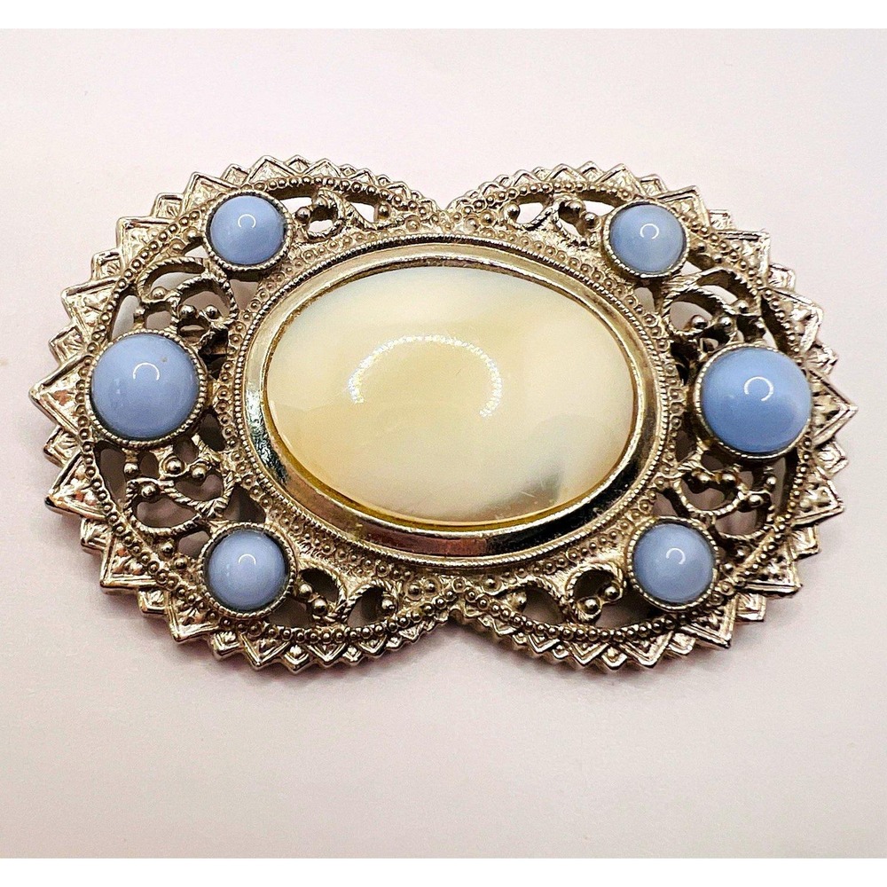 1928 Company Silvertone Filigree Brooch Pin White Cabochon w/ Blue Stone Accents